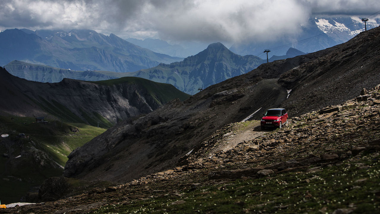 Red Range Rover in mountain
