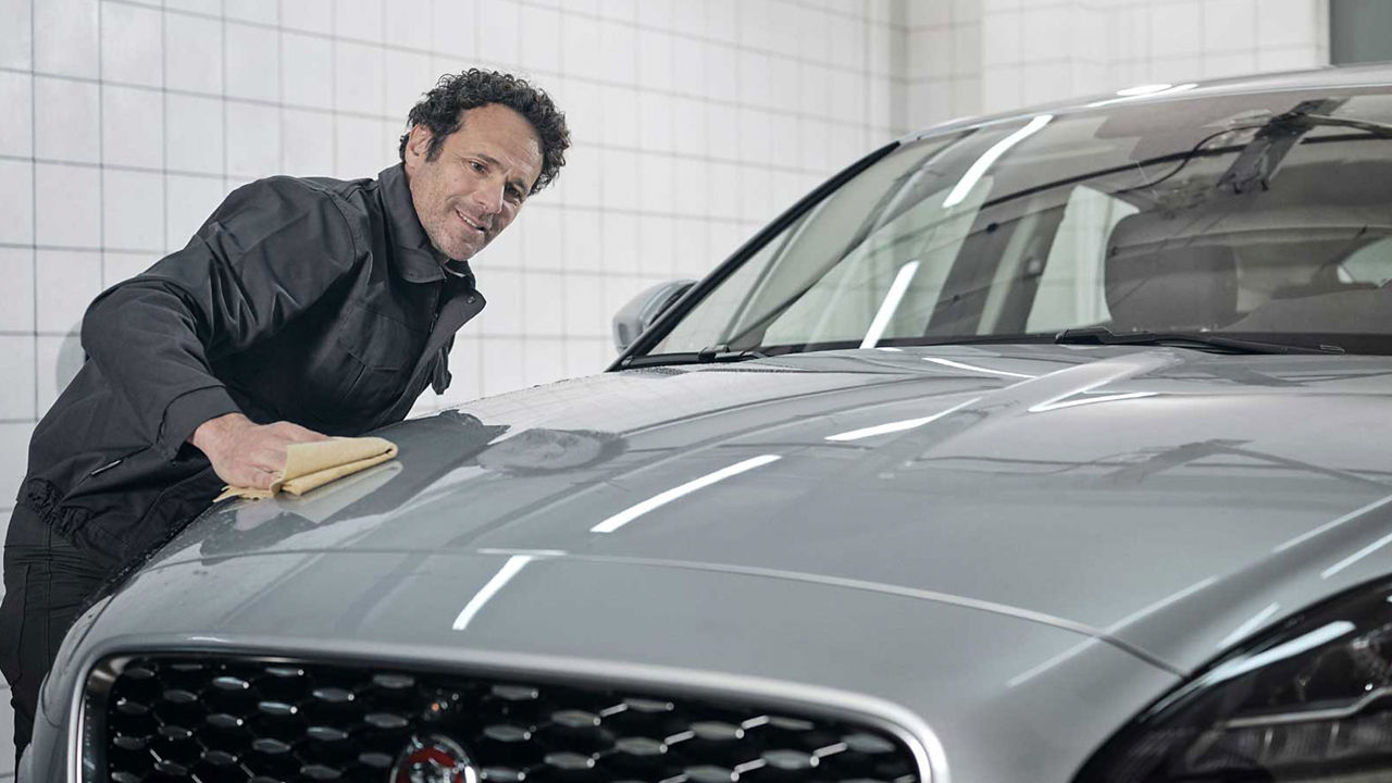 Jaguar service center mechanic checking vehicle