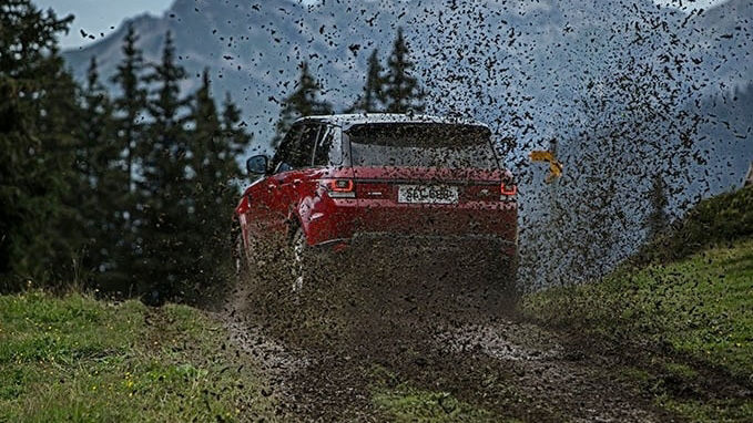 Range Rover Sport driving on a muddy hill 