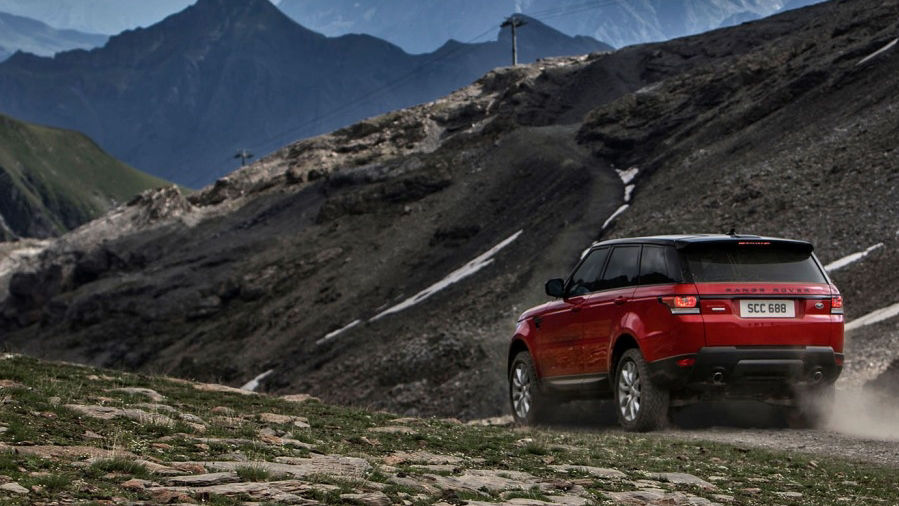 Red Range Rover driving through valley