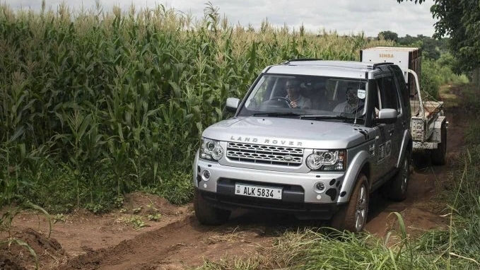 Range Rover driving through the fields