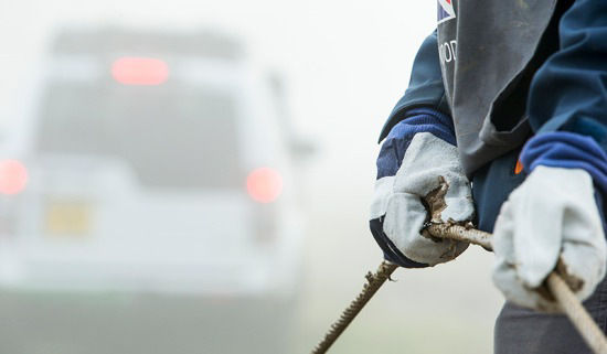 Person holding a winch rope 