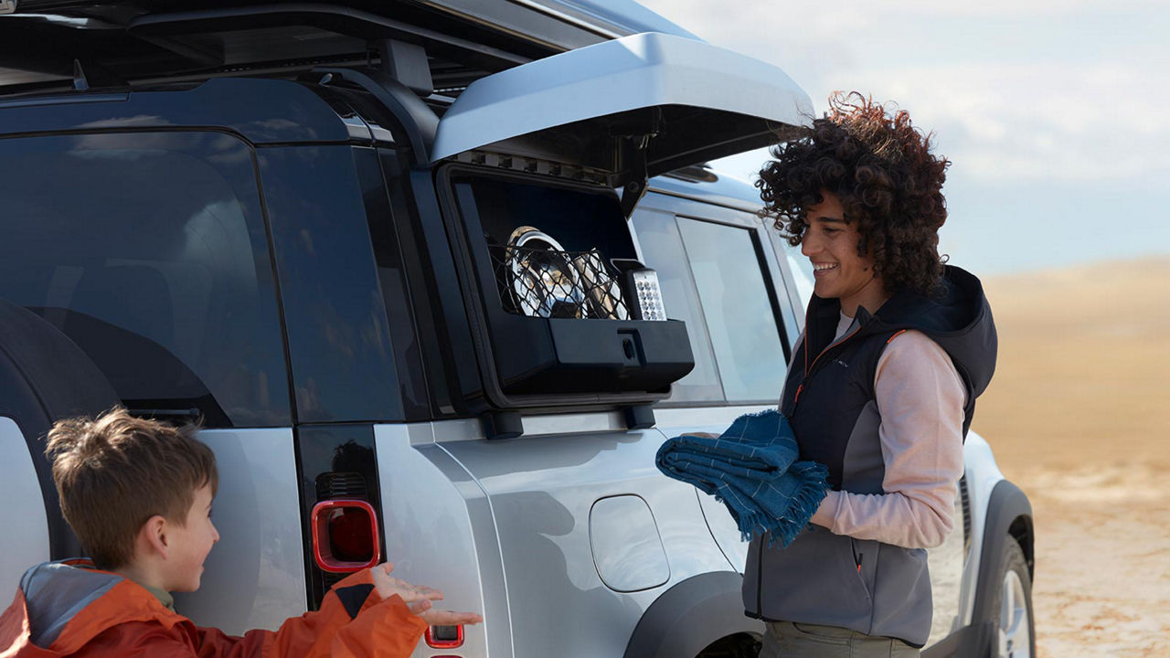 Land Rover Defender with woman and child 