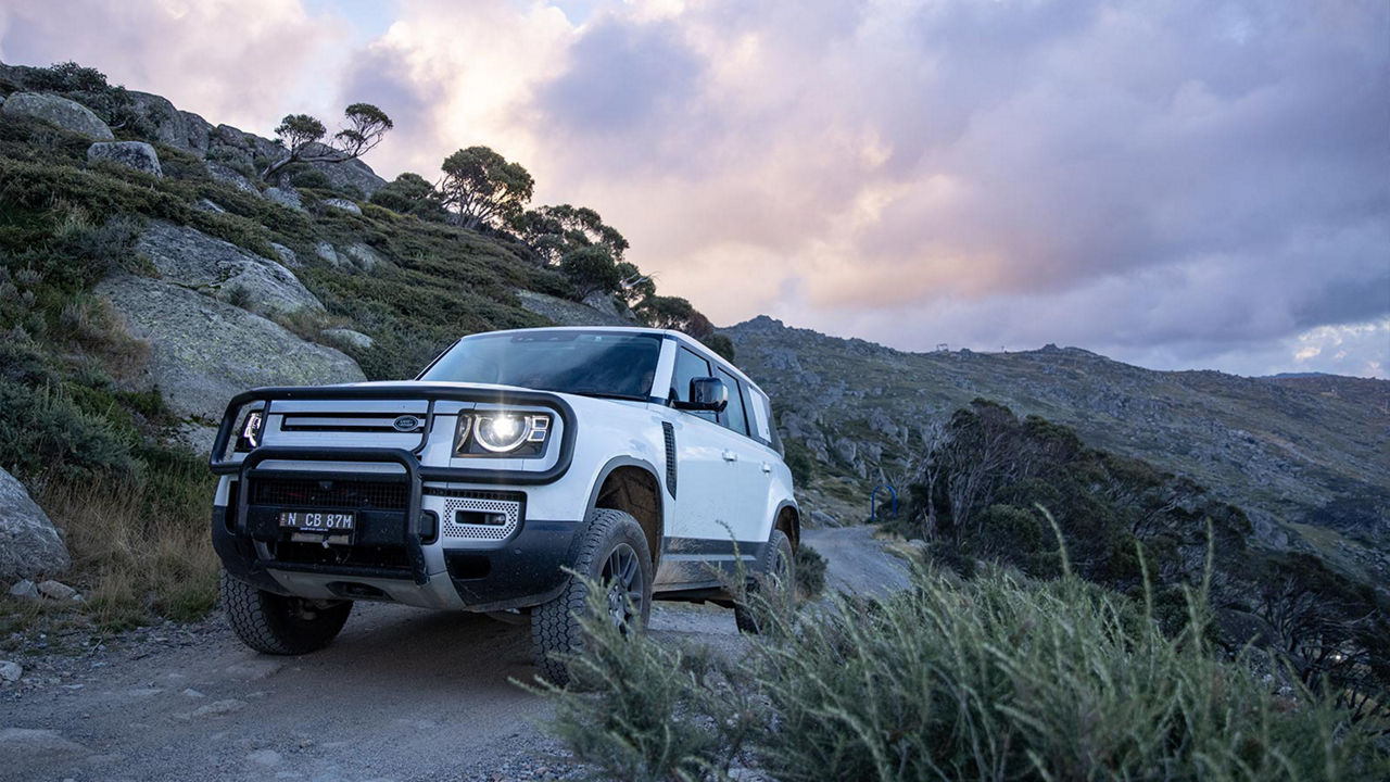 Defender driving up a mountain road