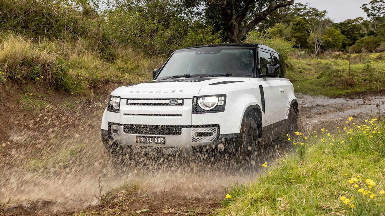 Defender driving through mud