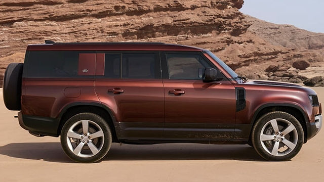 Defender side view in sand