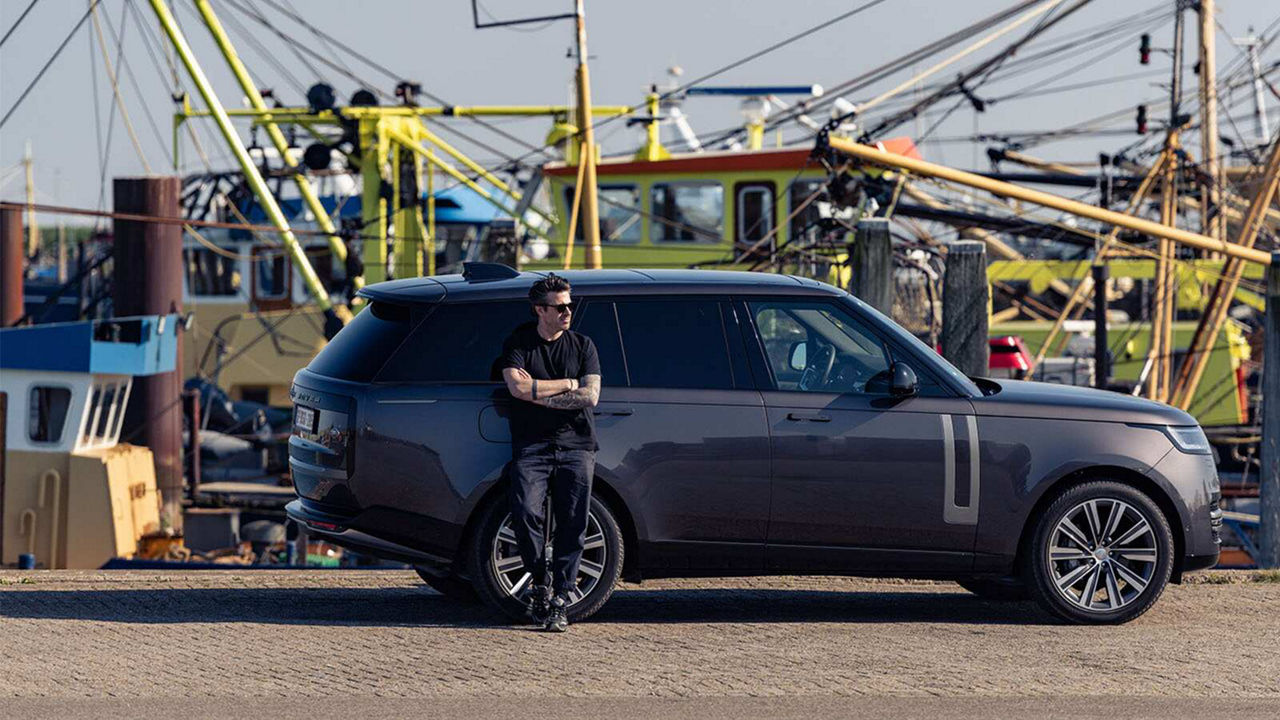 Sergio Herman Standing next to Land Rover Vehicle