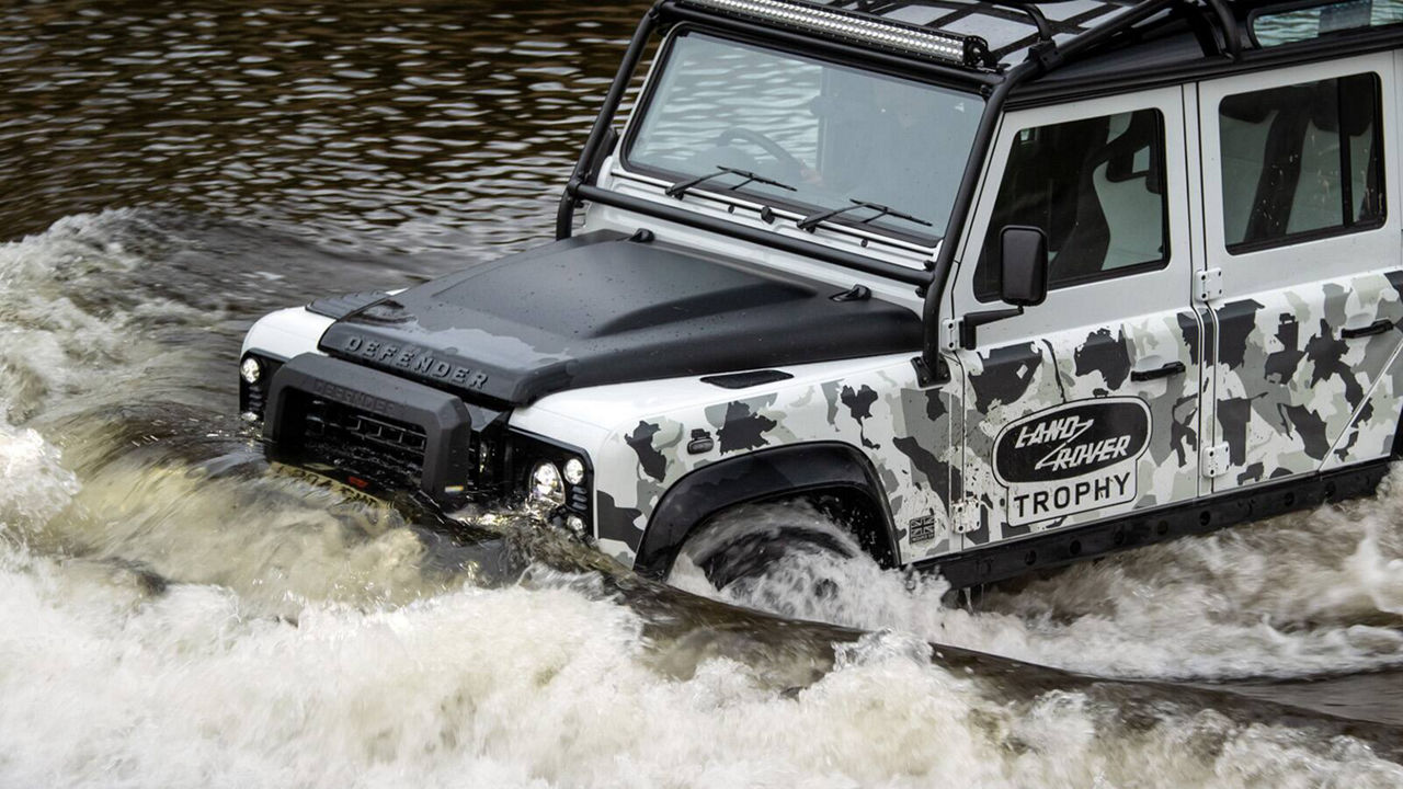 Range Rover Defender driving through water 