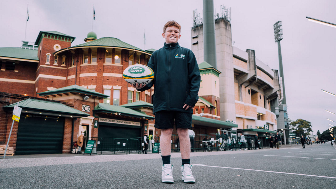 Boy holding a rugby ball