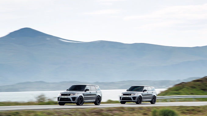 Two Range Rover Sports driving on a road