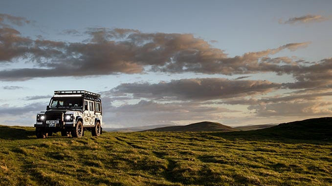 Classic Defender driving in fields