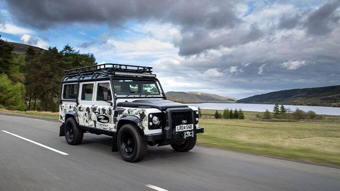 Defender driving on a road