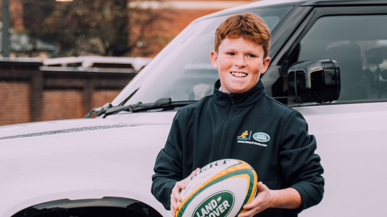 Boy holding a rugby ball