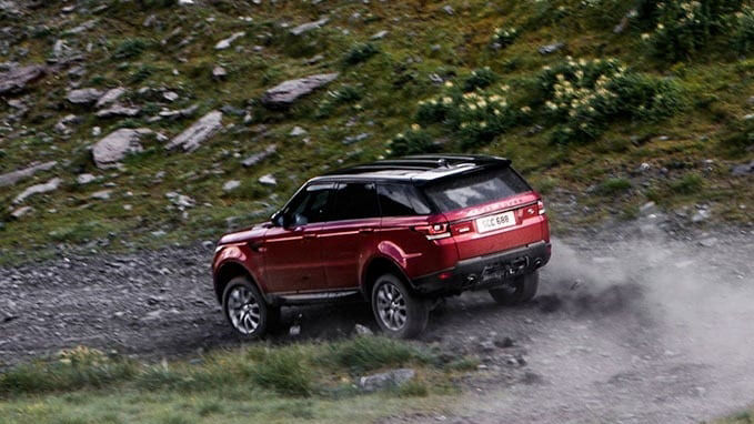 Red Range Rover dirt road