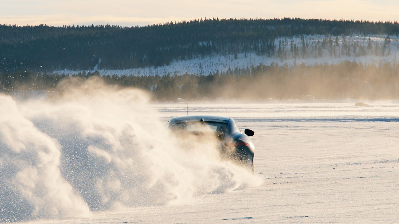 Jaguar F TYPE passes through a snowdrift and snowy land road