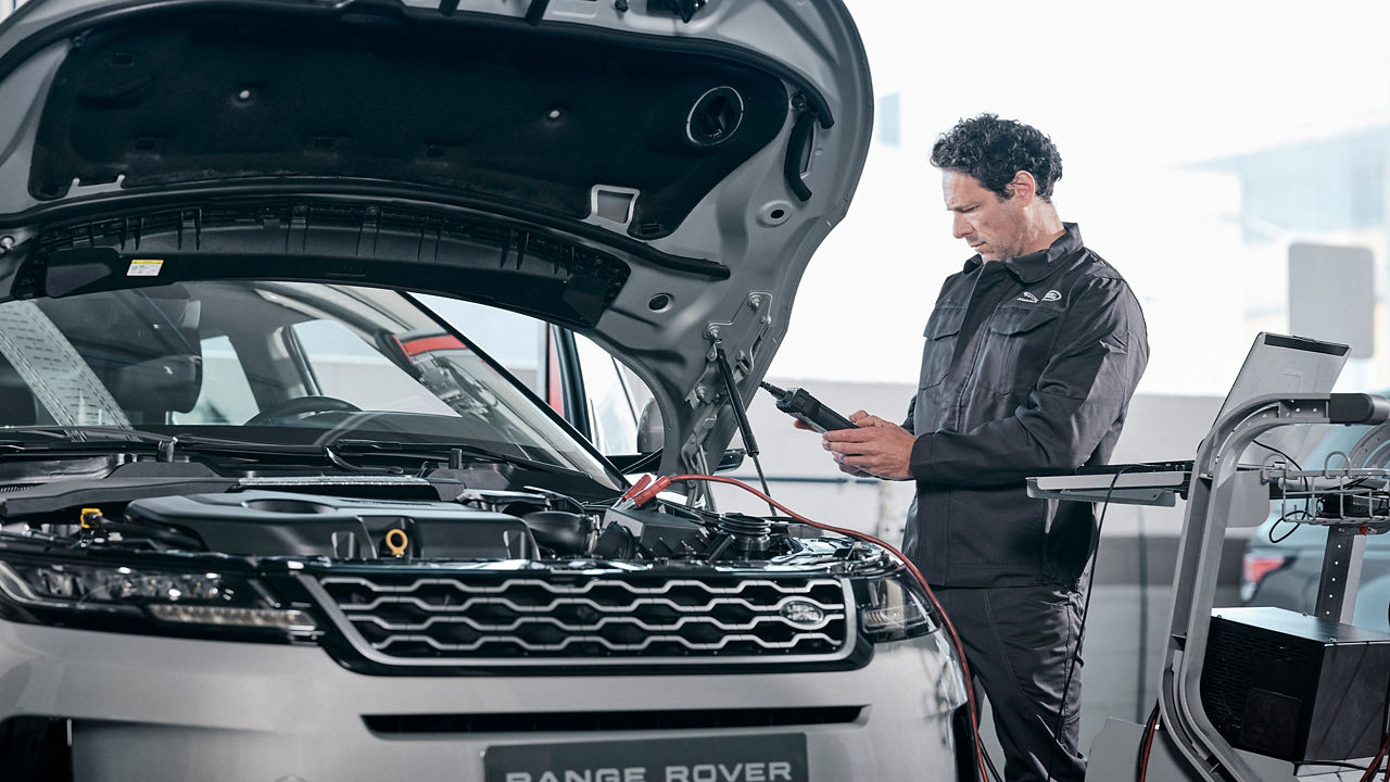 A person checking car in Land Rover Service center