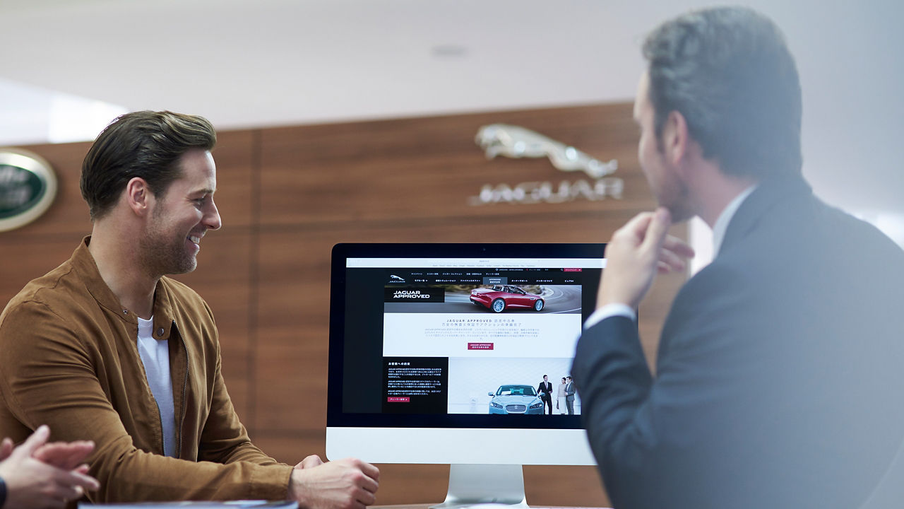 Businessman Presenting Website on Imac