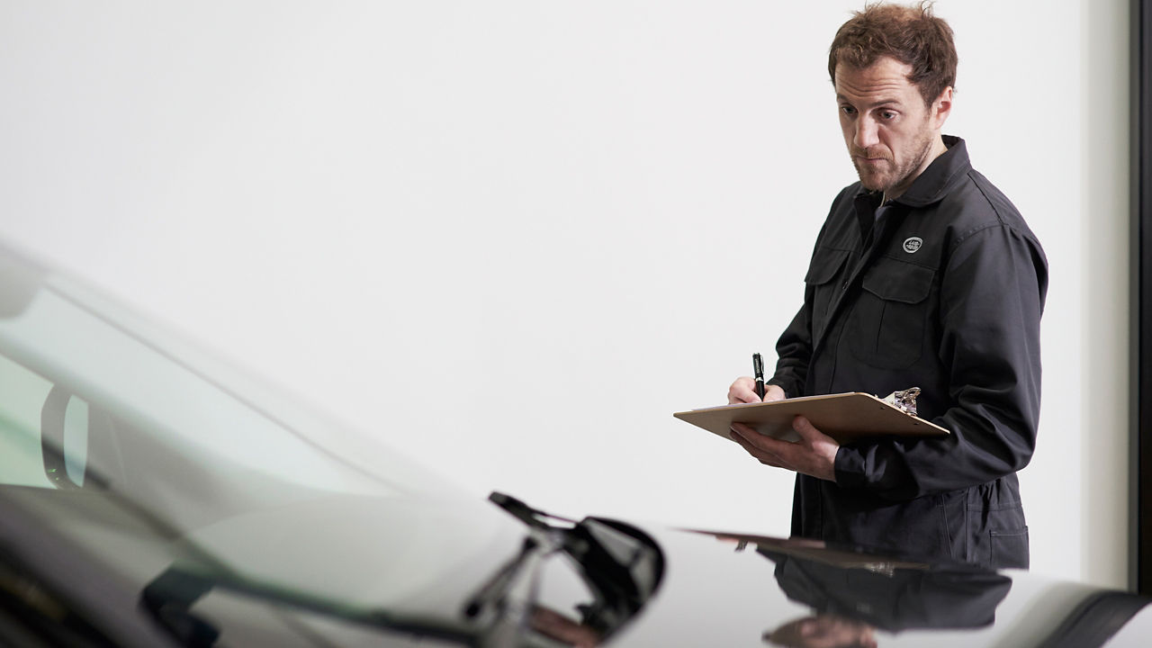 A person checking car in Land Rover Service center