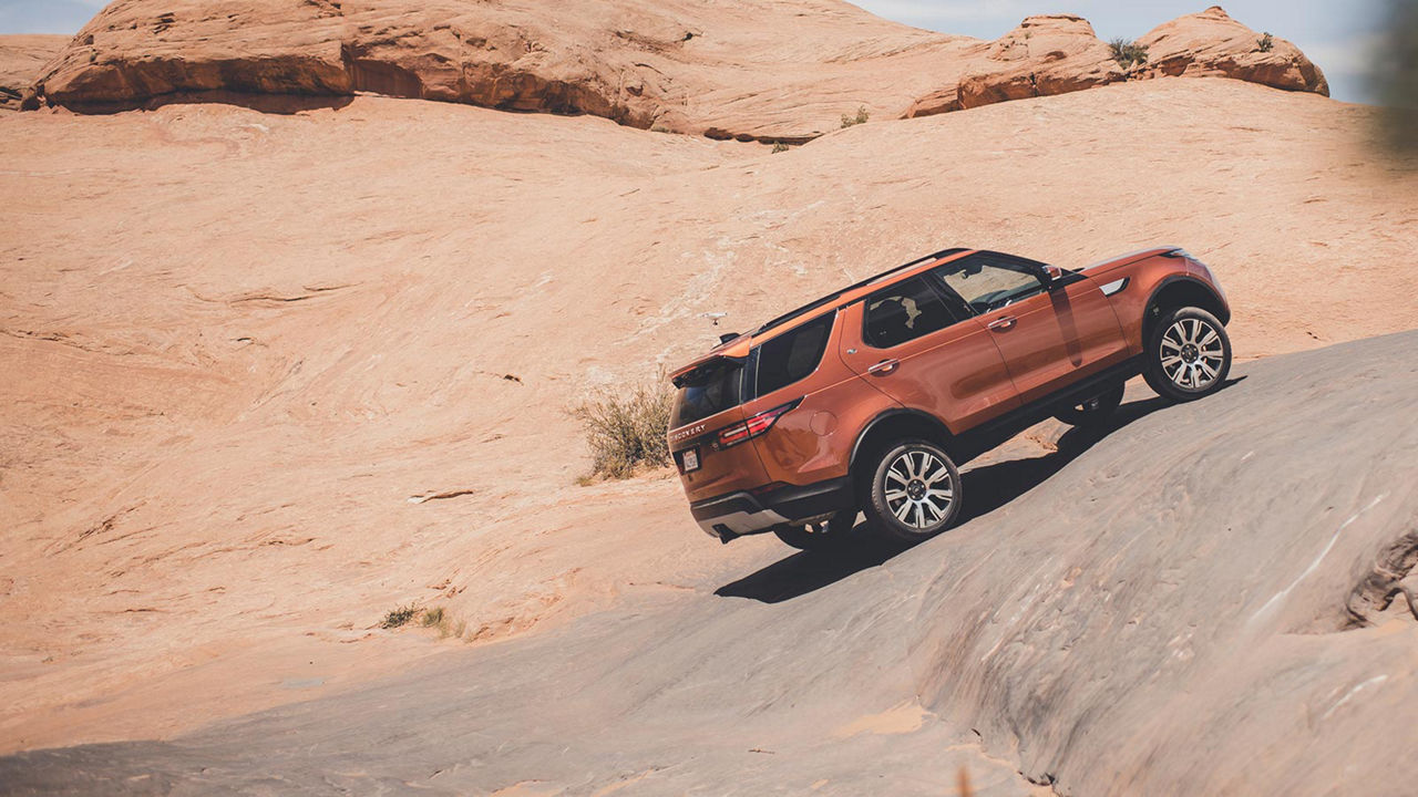 Range Rover Discovery driving up a hill