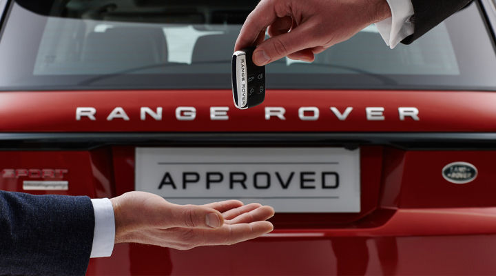 Red Range Rover with approved sign