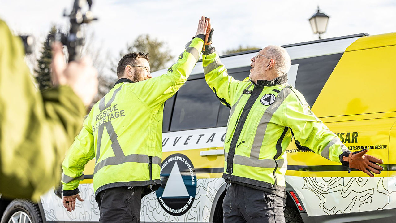 Two men doing hi-five cheers