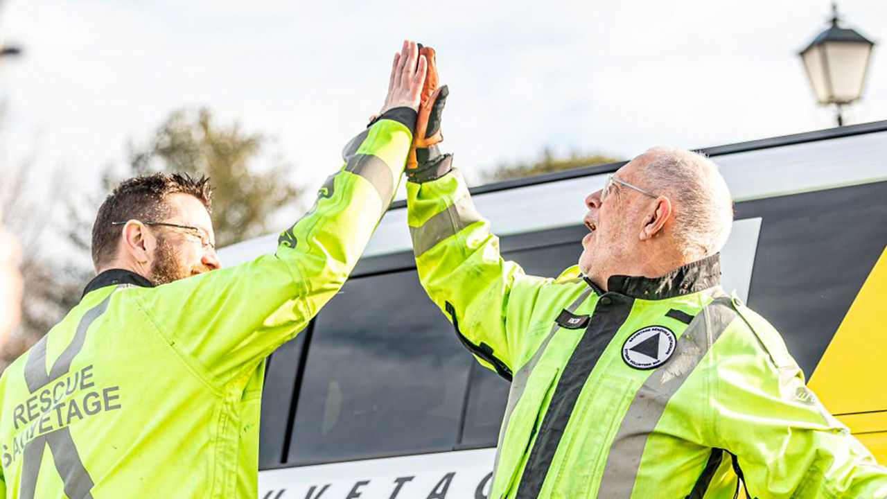 Two men giving high five