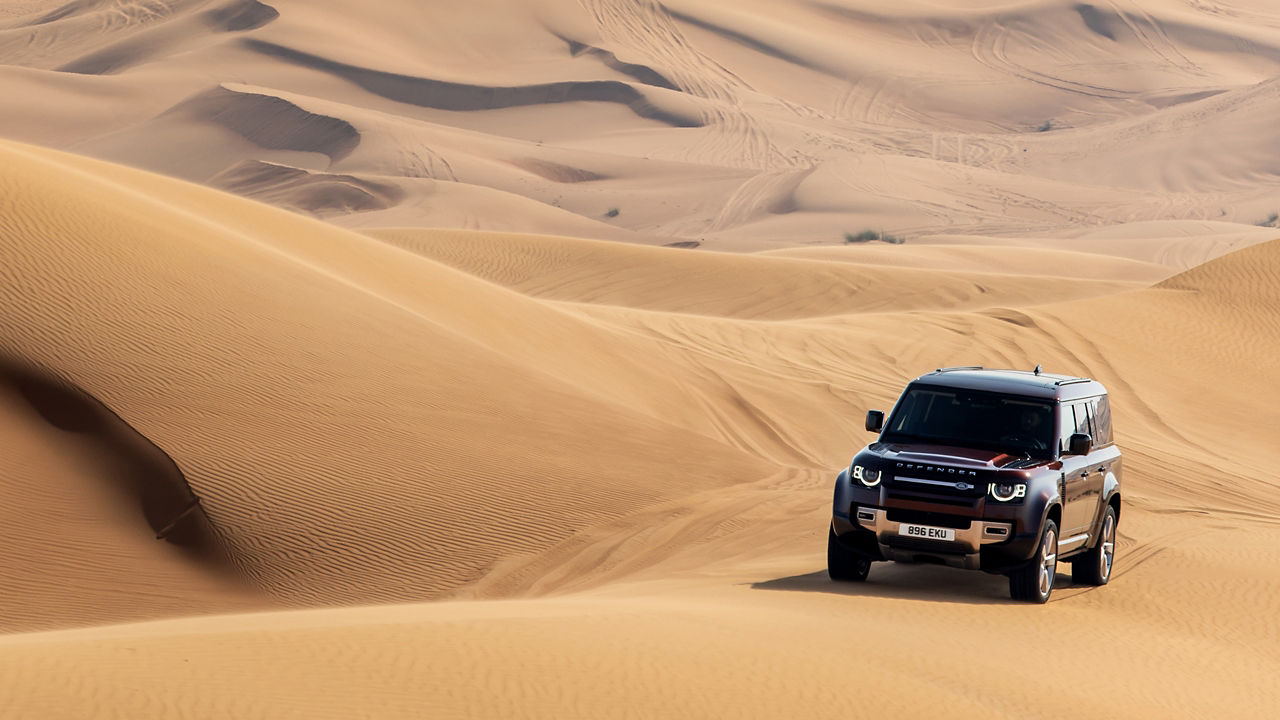 Defender driving in desert