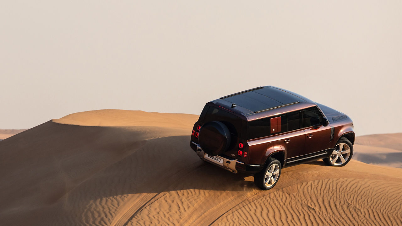 Defender driving on the desert