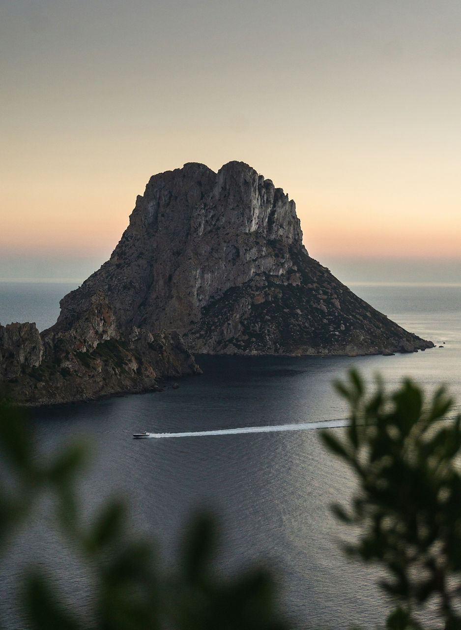 mountain with rocks in the middle of the sea