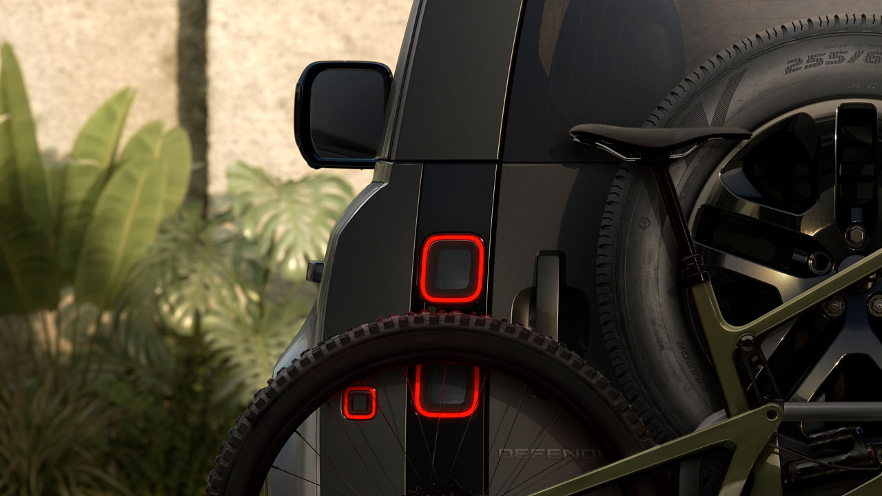 rear view of a defender with a bicycle on the trunk door