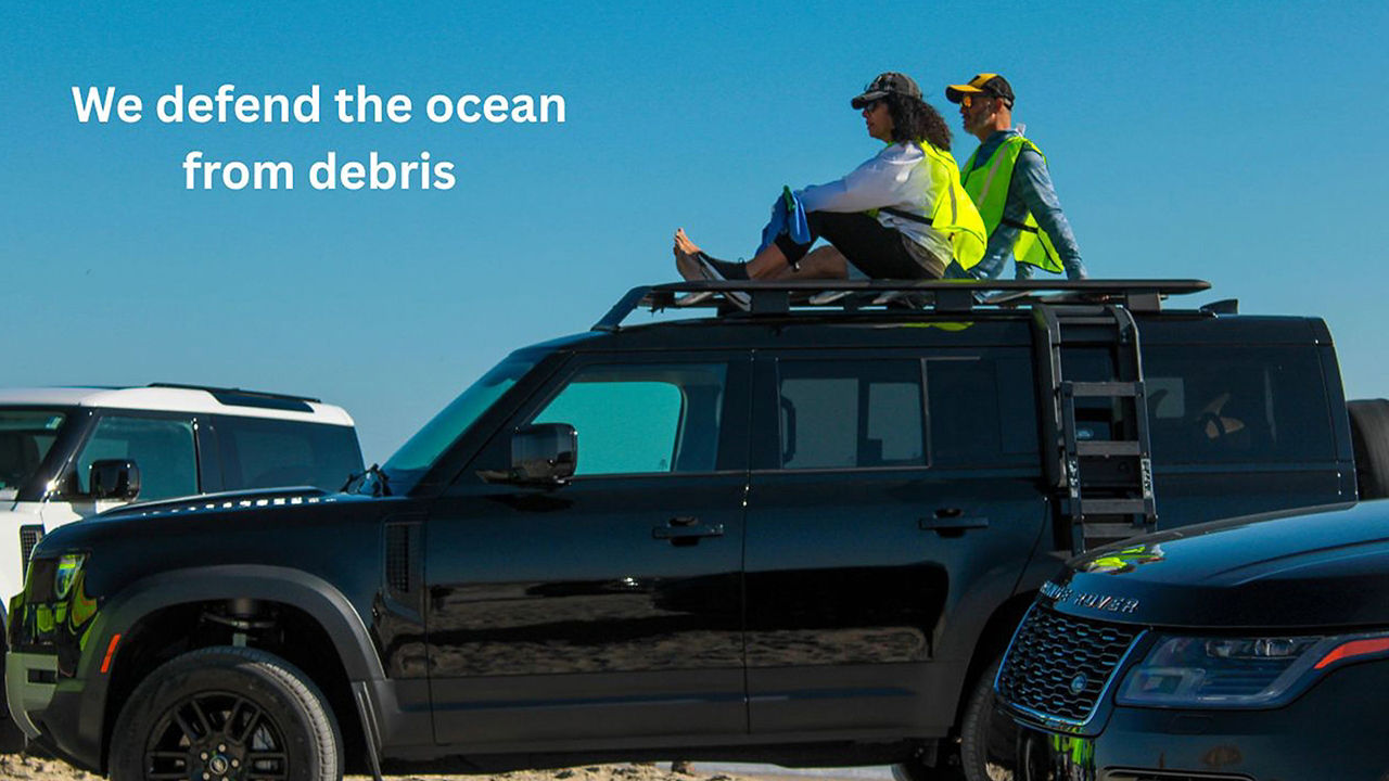 People sit on Defender rooftop