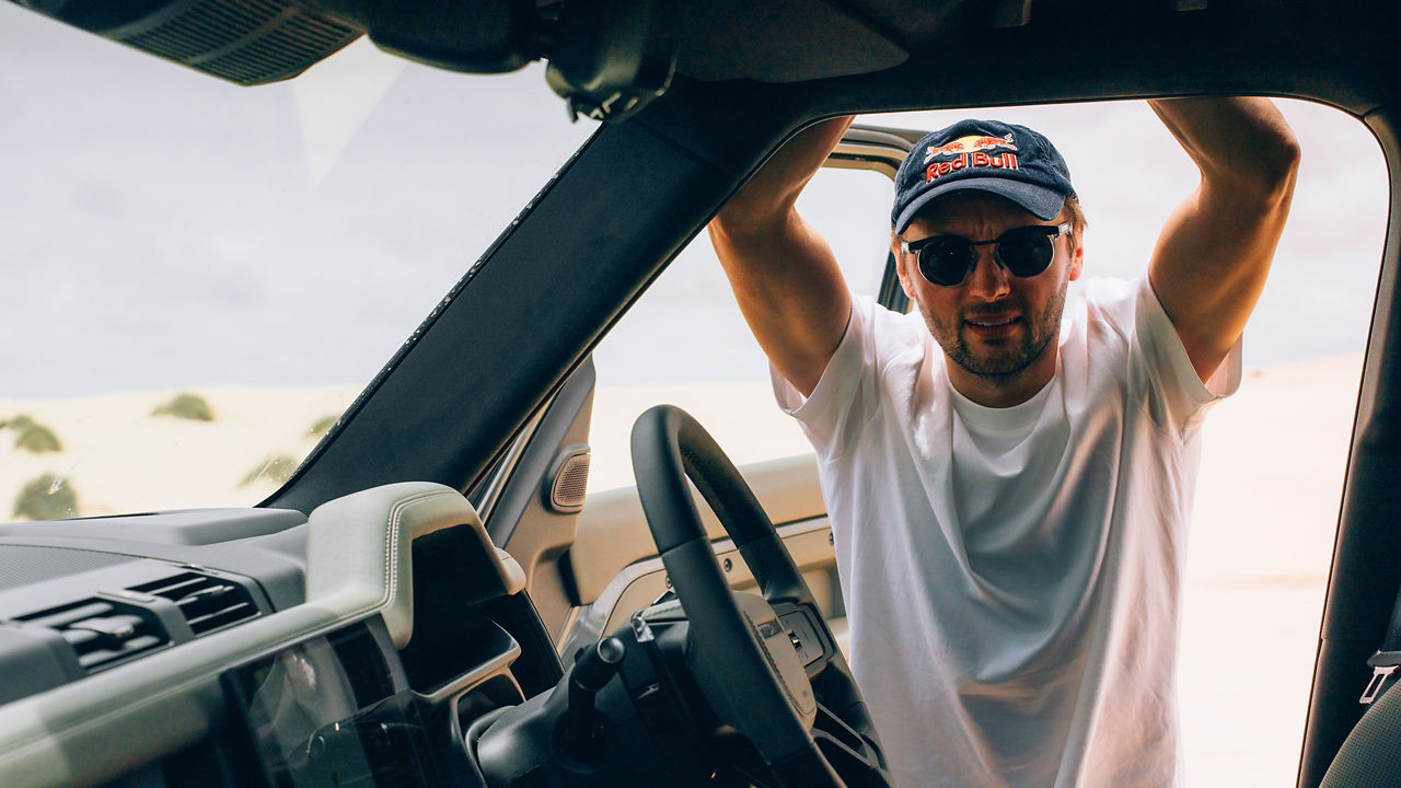 Pilot standing in the door of a defender 110