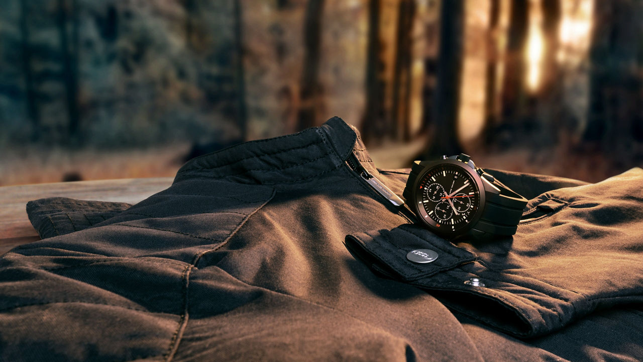 Jacket and watch on bench in forest