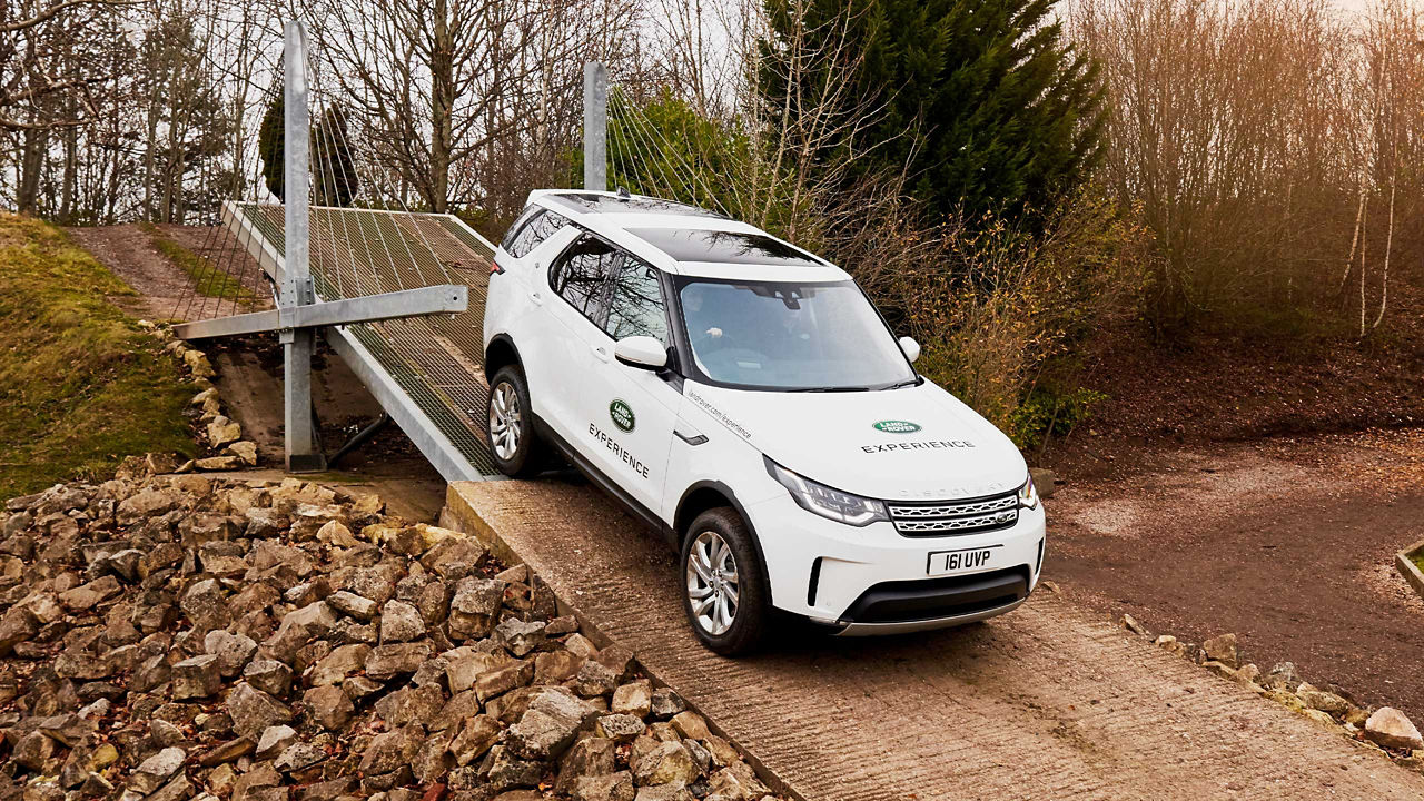 Range Rover Drives Over A small cable Bridge