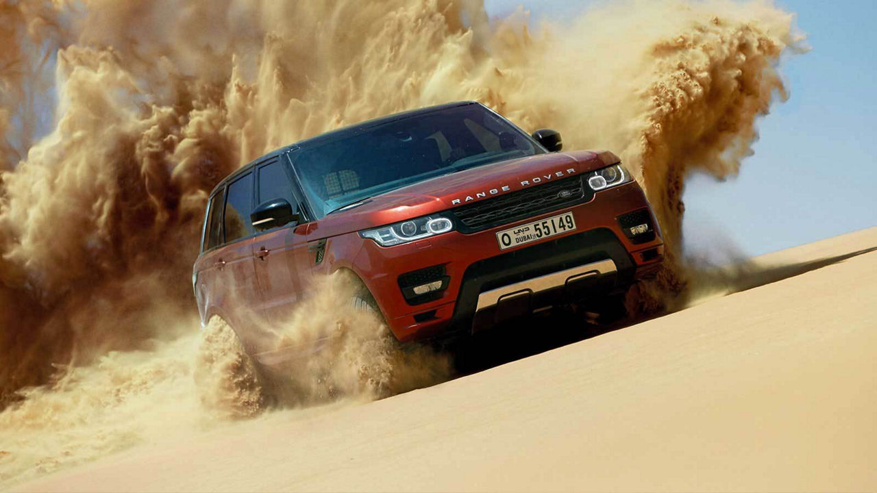 Land Rover Vehicle Driving Through Sand