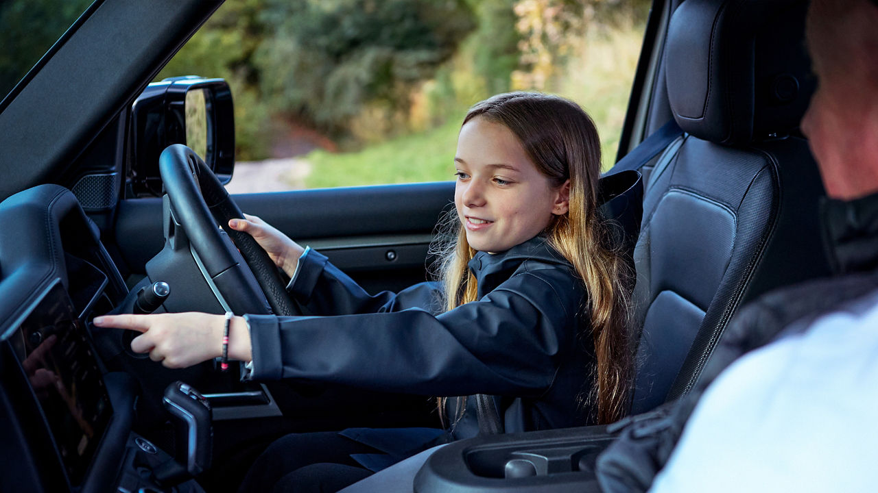Small girl driving defender