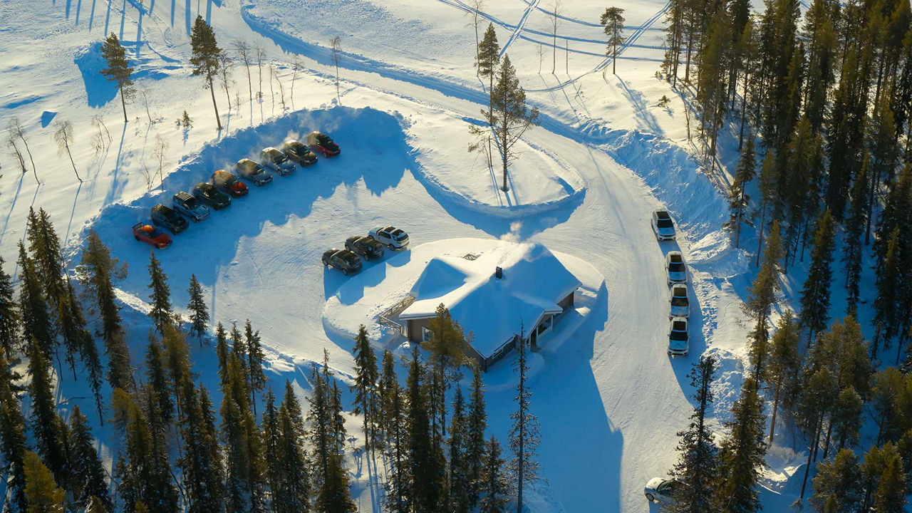 An aerial shot of a lodge in a snowy environment