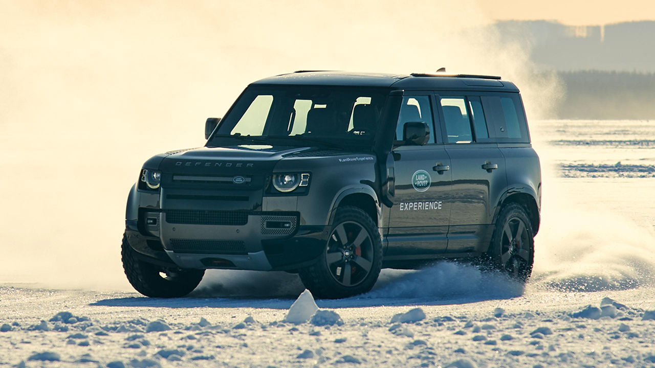 Land Rover Defender crossing on a Snow Forest Road