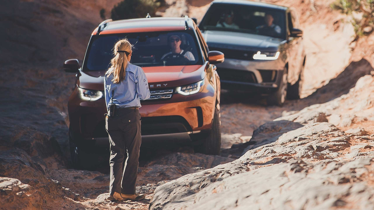 Range Rover driving in the mountains with women Instructor's help