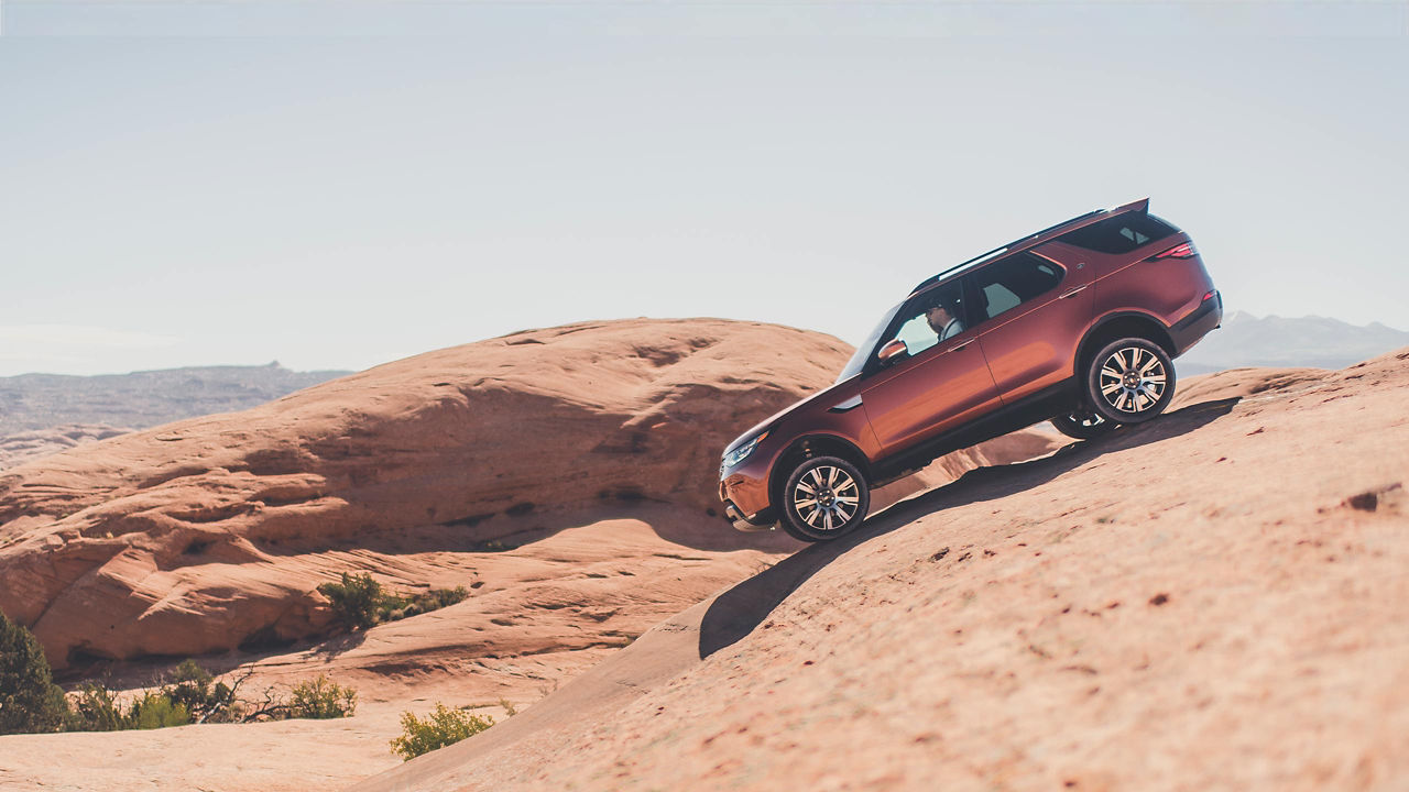 Discovery goes off road into the hilly mountains down the side.