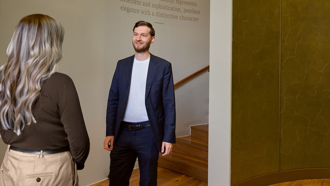 people having conversation near a staircase.