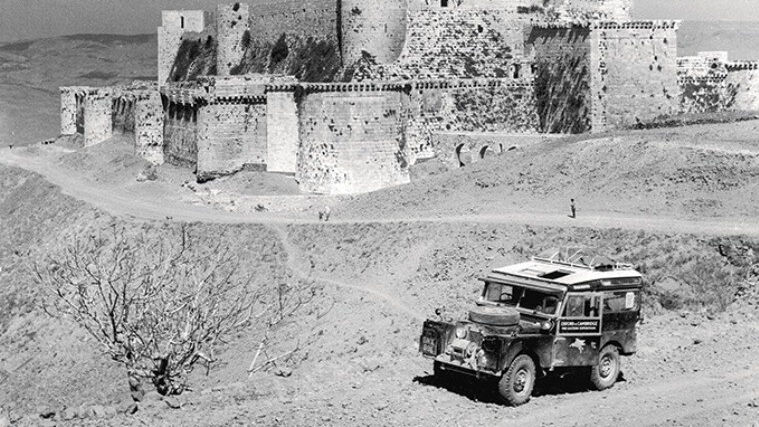 The Land Rover Defender parked outside a castle