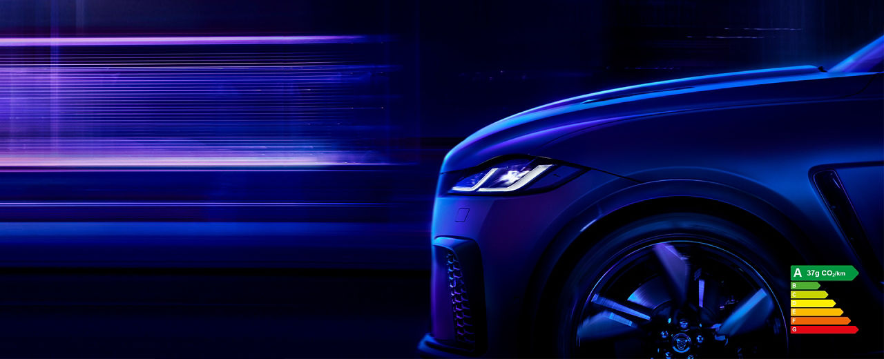 Side view of F-PACE driving through at night with energy efficiency label A (37g CO2/km)