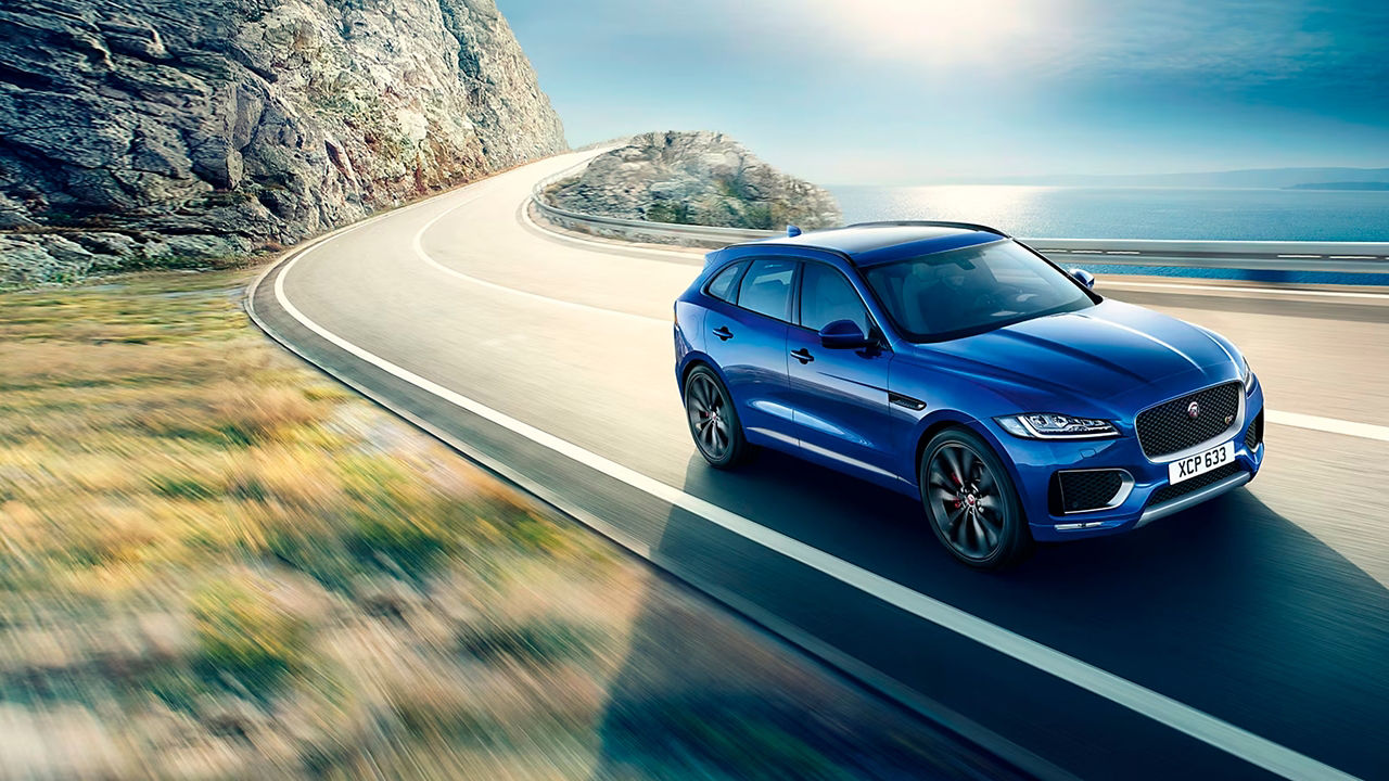 Jaguar F-Pace mountain road surrounded by sea