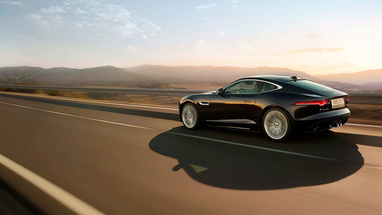 Jaguar F-TYPE Coupe running on highway road 