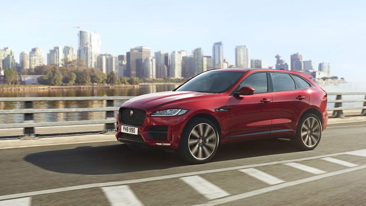 Jaguar F-Pace running on city highway bridge