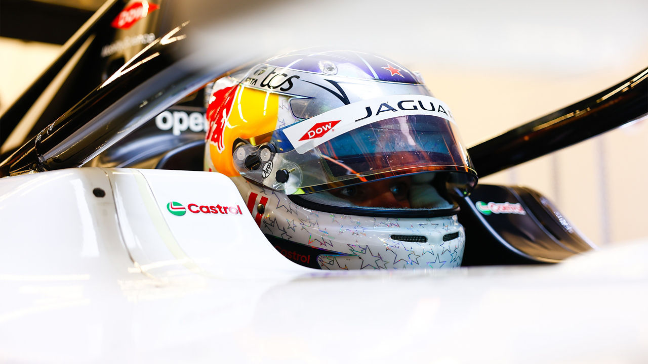 Nick Cassidy sitting in his car, helmet visor up