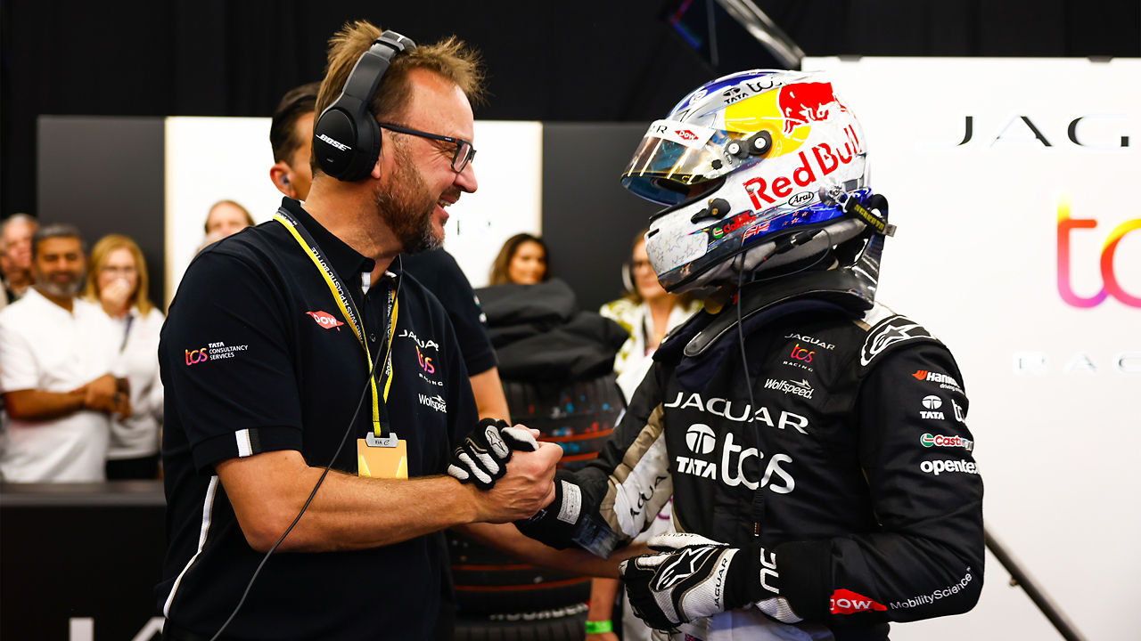 Nick Cassidy receiving congratulations from teammates in the pits