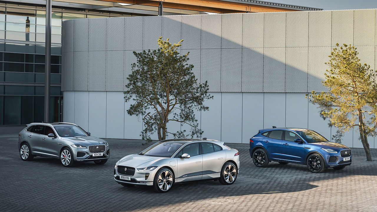 Jaguar PACE family parked outside building