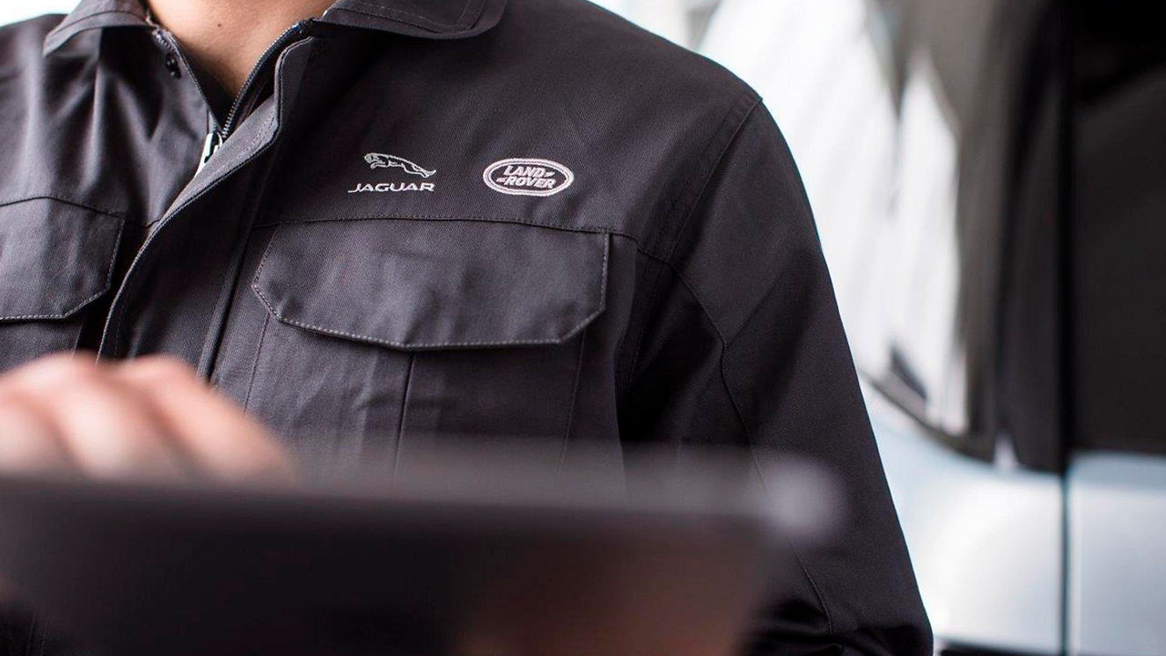 Jaguar service center mechanic checking vehicle